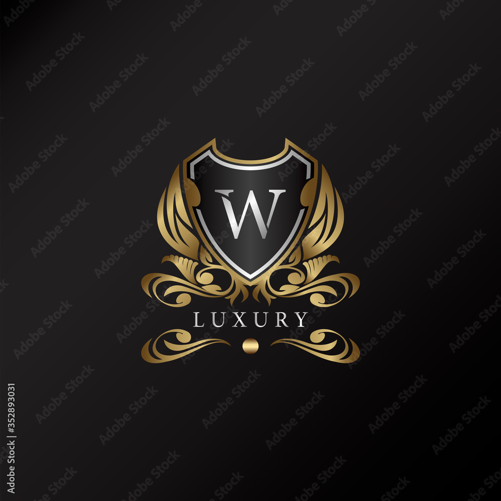 Shield logo in gold color with letter W Logo. Elegant logo vector template made of wide silver alphabet font on shield frame ornate style.
Shield logo in gold color with letter W Logo. Elegant logo vector template made of wide silver alphabet font on shield frame ornate style.