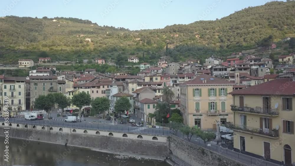 Drone shot of the small ancient village of Dolceacqua in Northern Italy in the morning sun during summer. Flying over the famous ancient bridge. Drone shot of the small ancient village of Dolceacqua in Northern Italy in the morning sun during summer. Flying over the famous ancient bridge.