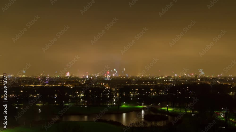 Beautiful 4K UHD aerial night timelapse video of the fireworks over the cityscape skyline of Amsterdam, the Netherlands, on New Years Eve (NYE) Beautiful 4K UHD aerial night timelapse video of the fireworks over the cityscape skyline of Amsterdam, the Netherlands, on New Years Eve (NYE)