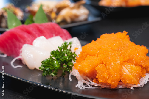 Japanese Sushi. Tobiko sushi mixed with Salmon set in ceramic plate. Japanese food