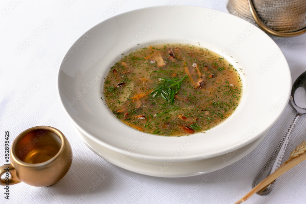Mushroom soup in white bowl. Close-up view. Mushroom soup in white bowl. Close-up view.