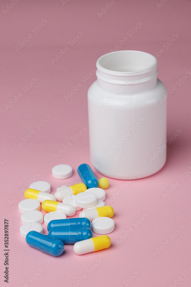 Assorted pharmaceutical medicine pills, tablets and capsules over a pink background Assorted pharmaceutical medicine pills, tablets and capsules over a pink background