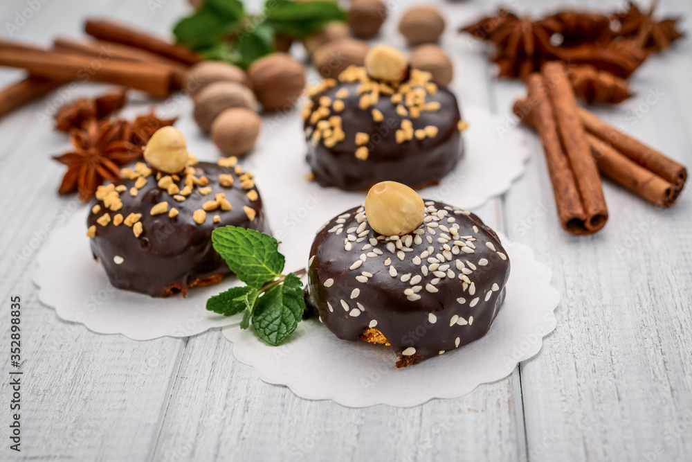 Delicious chocolate cakes on table close-up, with nuts Delicious chocolate cakes on table close-up, with nuts