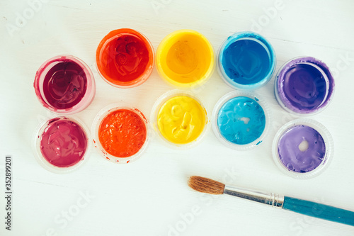 Wallpaper Mural Colorful gouache paints and brush for painting on white wooden table. Top view. Copy, empty space for text Torontodigital.ca