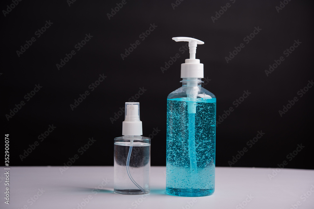 Plastic dispenser sanitizer alcohol gel pump and spray bottle for washing hand hygiene prevention of coronavirus virus studio shot on black background Plastic dispenser sanitizer alcohol gel pump and spray bottle for washing hand hygiene prevention of coronavirus virus studio shot on black background