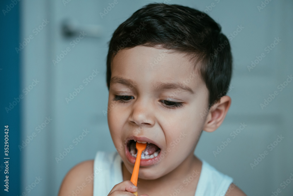 cute, diligent boy brushing teeth in bathroom cute, diligent boy brushing teeth in bathroom