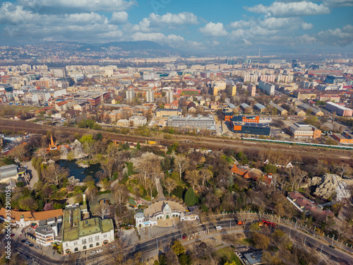 Beautiful top view of the zoo in Budapest. Top view of the railway, houses and city park. Spring. Mountains and beautiful clouds in the background.