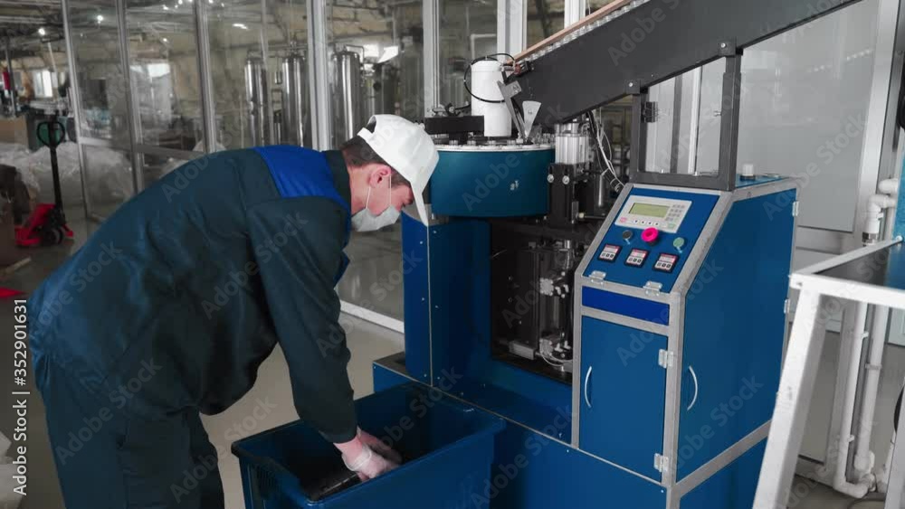 Pure water plant. Work conveyor boosting a liter plastic bottle. Workers monitor the assembly line. 4k Pure water plant. Work conveyor boosting a liter plastic bottle. Workers monitor the assembly line. 4k