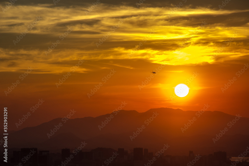 silhouette of a plane with a beautiful sunset seen from the city of Niteroi park. silhouette of a plane with a beautiful sunset seen from the city of Niteroi park.