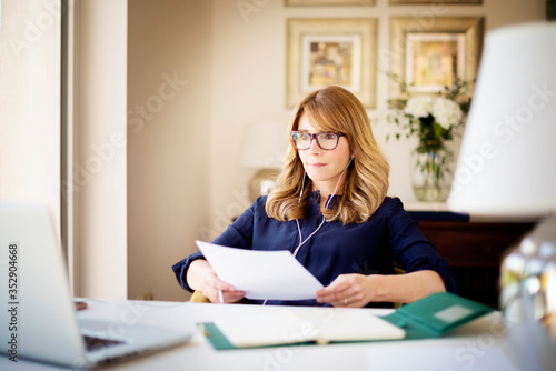 Shot of woman sitting behind her laptop and working from home