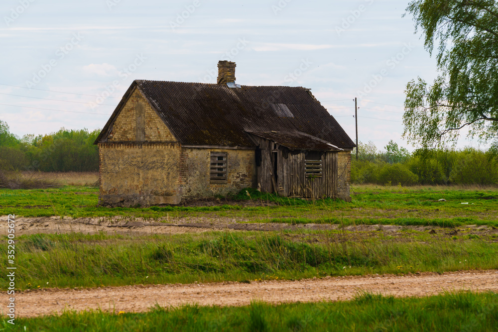 Obraz premium Very old abandoned agricultural buildings of the 19th century in a Latvian village, May 2020.