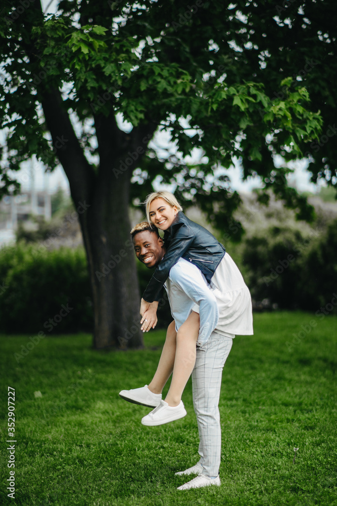 Young interracial couple has a fun and laughs in park. Young interracial couple has a fun and laughs in park.
