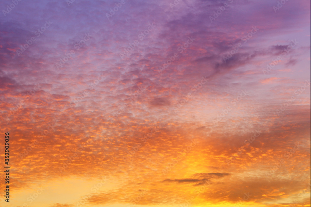 Evening sky and clouds. Orange and blue sky background. Spindrift clouds.