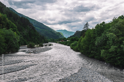 A picturesque landscape view of the valley of Var river in the Alps mountains on a cloudy afternoon (Puget-Theniers, Alpes-Maritimes, France)