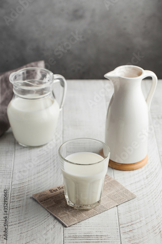  Glass of milk, jug of milk. The concept of milk, dairy products, agricultural products. Minimalism. Copy space.