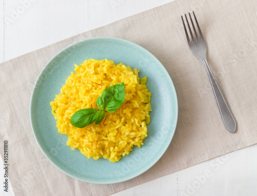 Risotto Milanese, the dish with traditional Italian saffron risotto. Top down view.