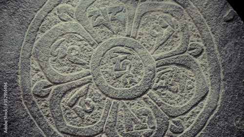 A close up of engraved symbols on stone