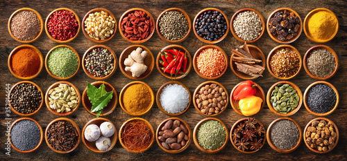 Fototapeta Naklejka Na Ścianę i Meble -  Colourful background from various herbs and spices for cooking in bowls