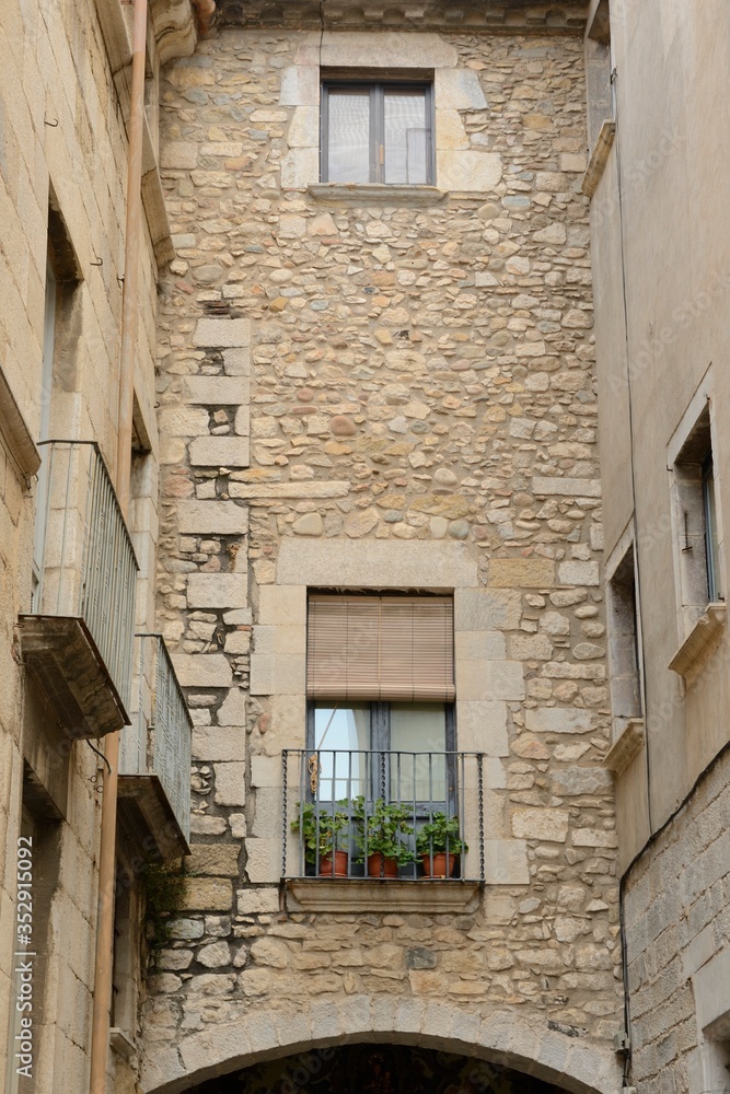 Stone facade over arch in Girona, Spain