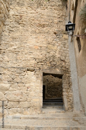 Old gate in medieval alley  in Girona, Spain