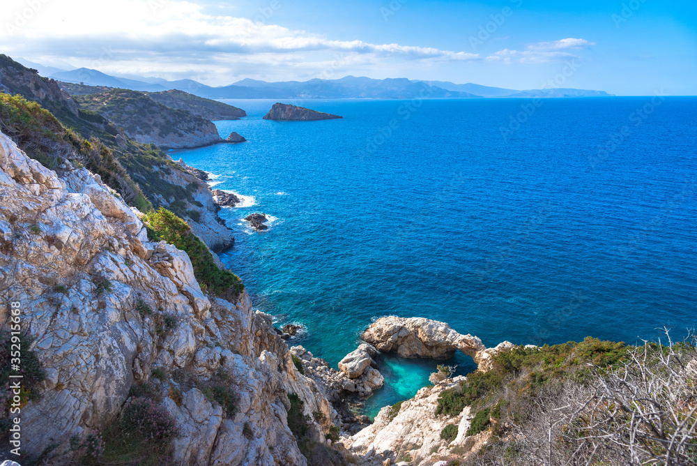 A small sea lagoon with a stone arch, gulf of Mirambello, Crete, Greece