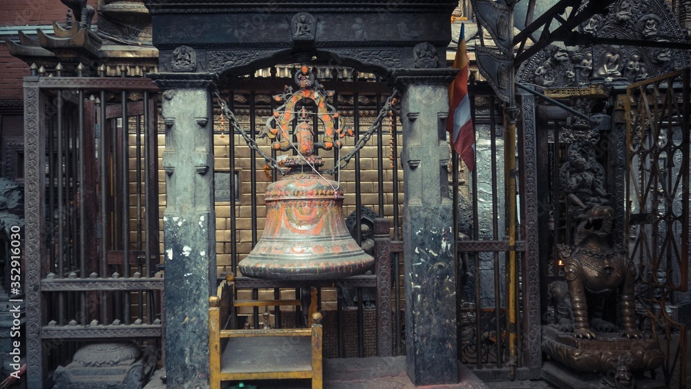 A full view of bell with chain and painted