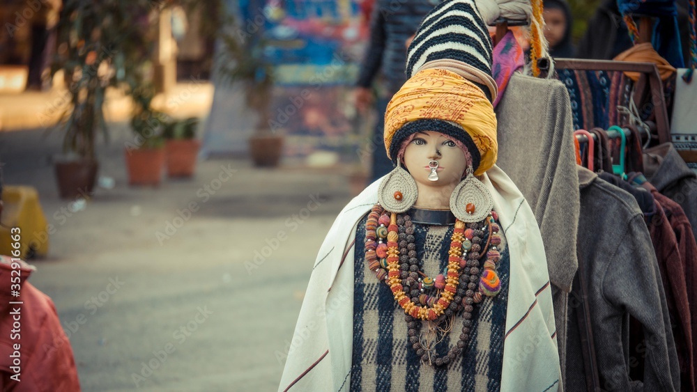 A mannequin wearing cloth and some jewelly