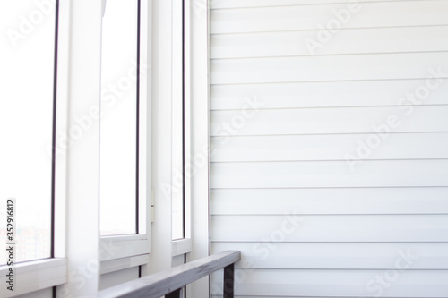 White balcony with railing and light from the window