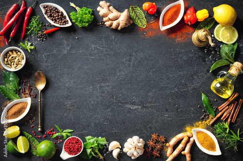 Fototapeta Naklejka Na Ścianę i Meble -  Colourful various herbs and spices for cooking on dark background