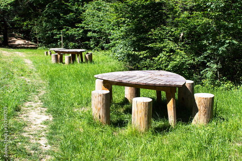 Wooden table with chairs green grass rest family picnic forest area