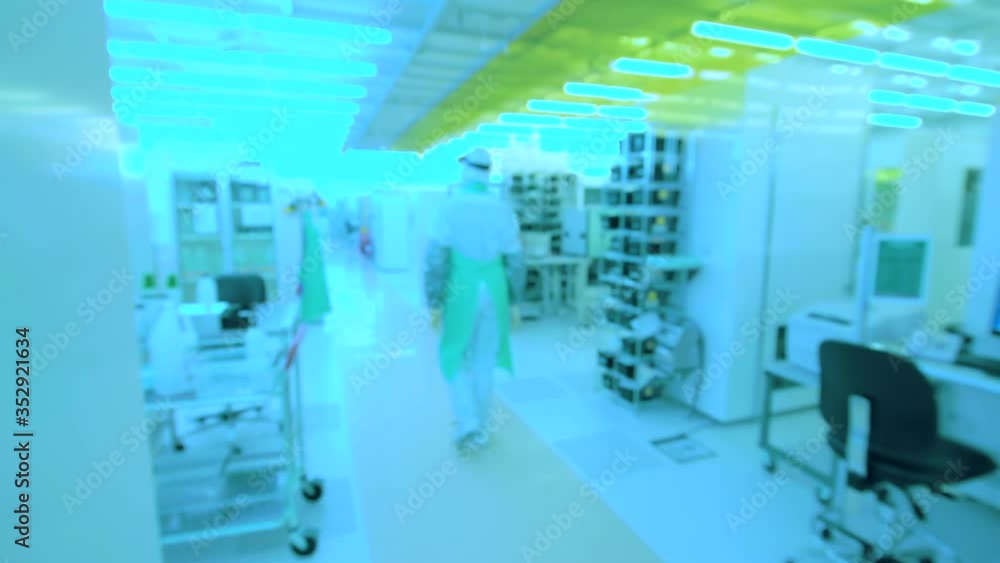 Researcher walking in biological laboratory with blue lights. Slow motion Researcher walking in biological laboratory with blue lights. Slow motion