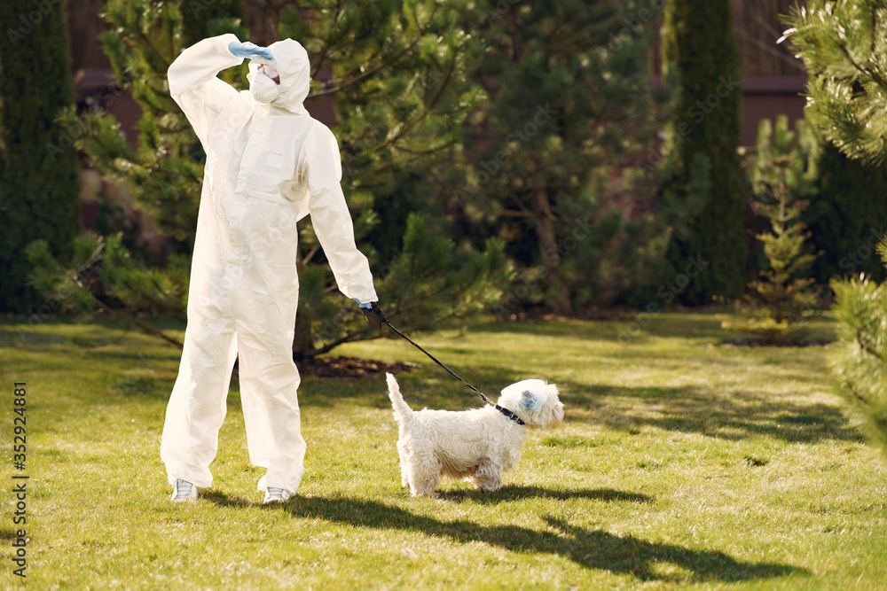 Woman in a protective suit. Person in a mask. Woman with a dog. Woman in a protective suit. Person in a mask. Woman with a dog.