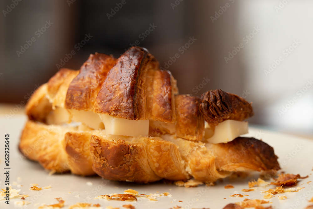crispy homemade croissant with cheese on a plate