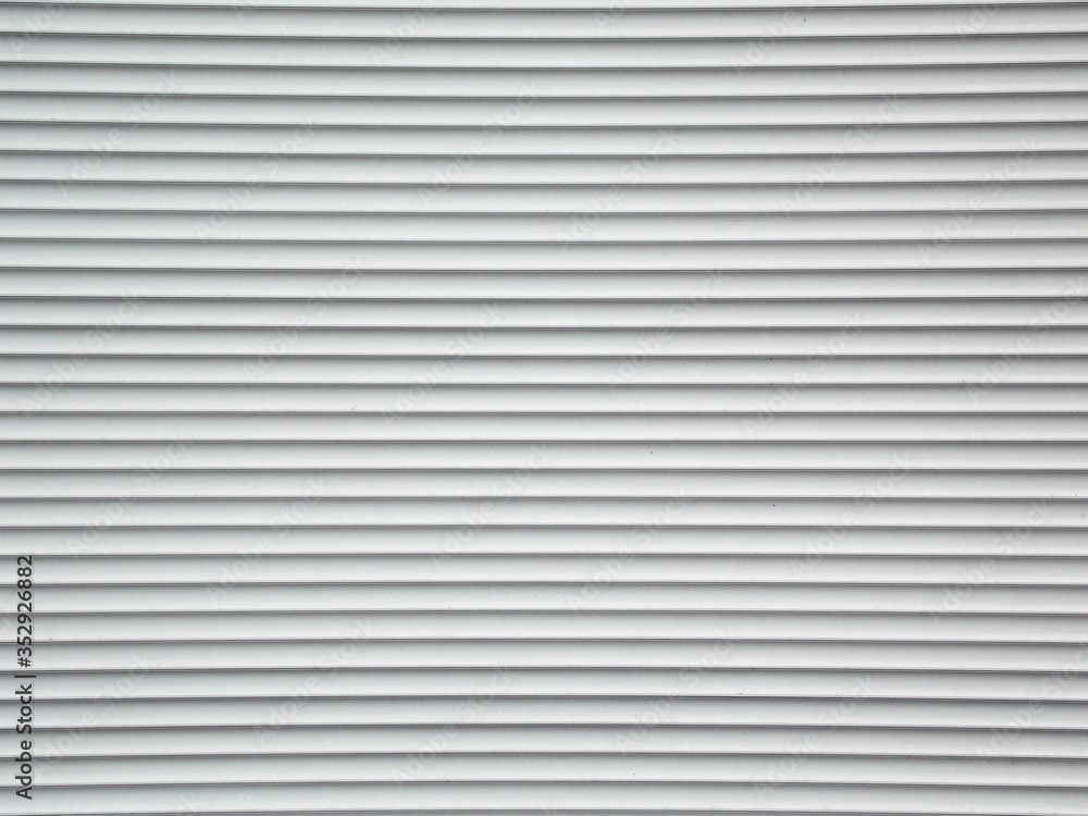 Plastic white closed shutters. Closed door surface. Plastic white closed shutters. Closed door surface.