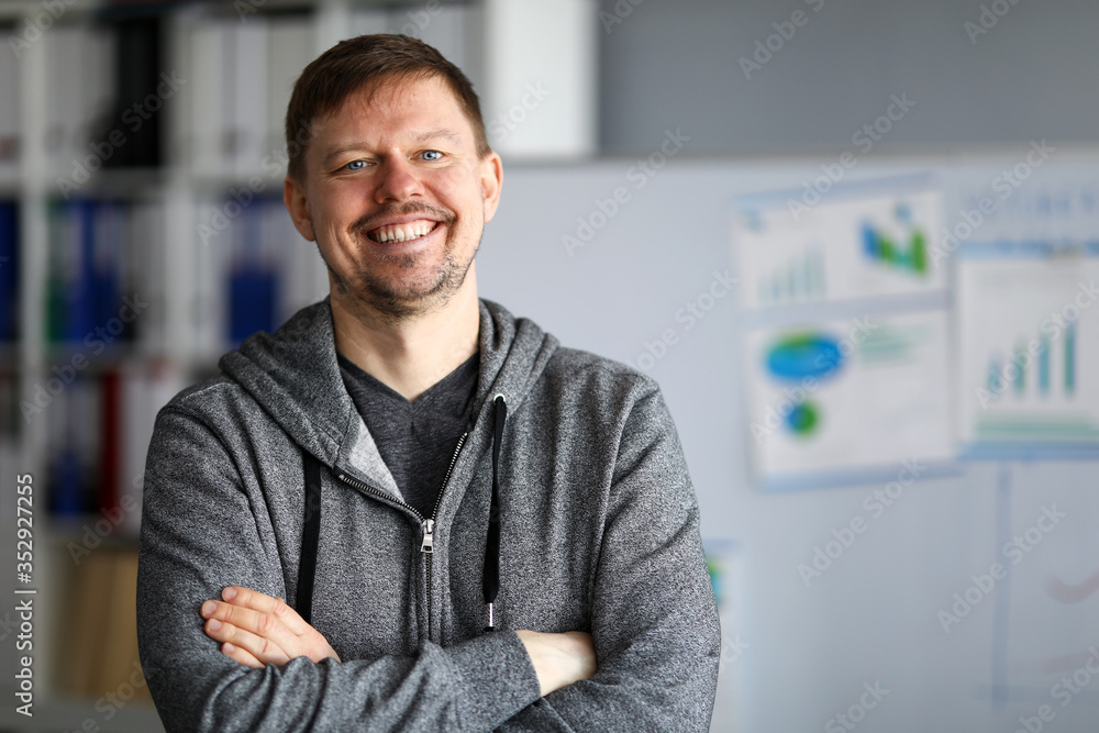 Happy man in casual wear is standing and smiling Happy man in casual wear is standing and smiling