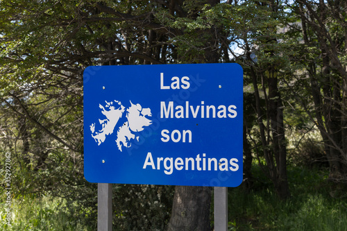 Signboard 'Las Malvinas son Argentinas' with Malvinas (Falkland) islands archipelago map near End of the World viewpoint, Lapataia bay in Tierra del Fuego national park, Ushuaia, Argentina