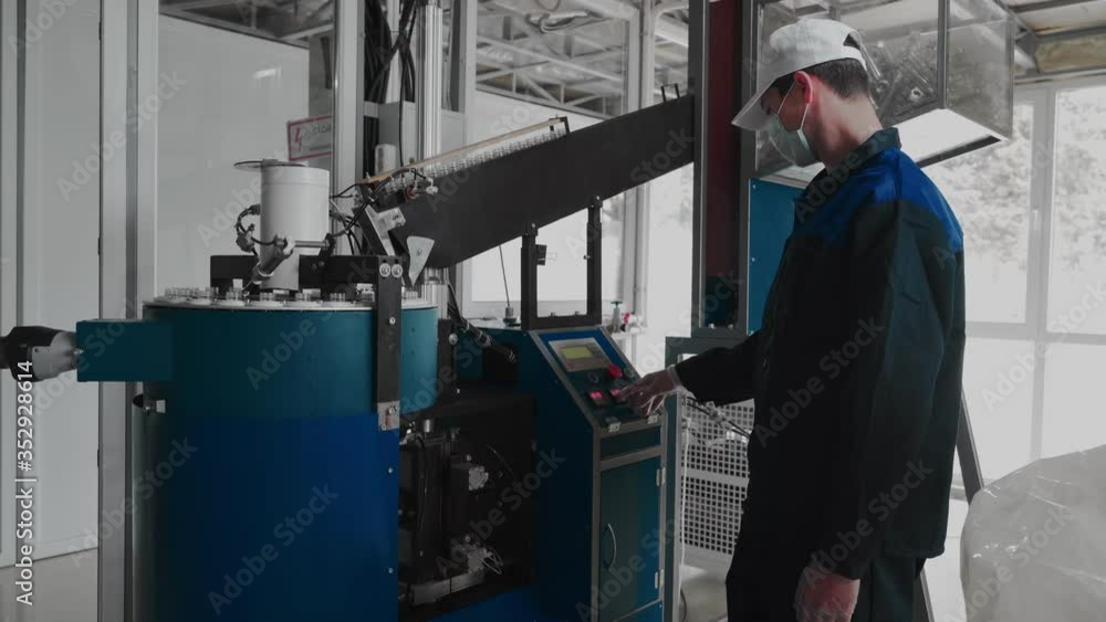 Pure water plant. Work conveyor boosting a liter plastic bottle. Workers monitor the assembly line. 4k Pure water plant. Work conveyor boosting a liter plastic bottle. Workers monitor the assembly line. 4k