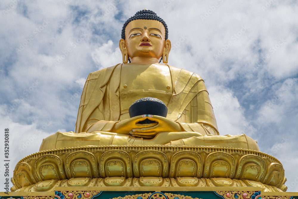 Fototapeta premium Big golden statue of the last historical Buddha, Shakyamuni (Siddhartha Gautama) in Buddha park, Swayambhunath area, Kathmandu, Nepal.