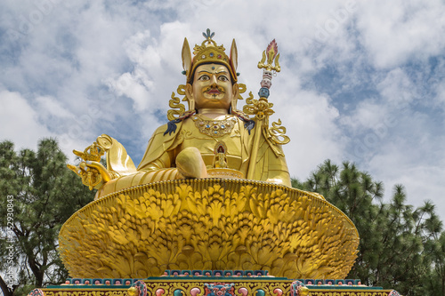 Big golden statue of Indian tantric master Padmasambhava (Guru Rinpoche) on a lotus throne in Buddha park, Swayambhunath area, Kathmandu, Nepal.