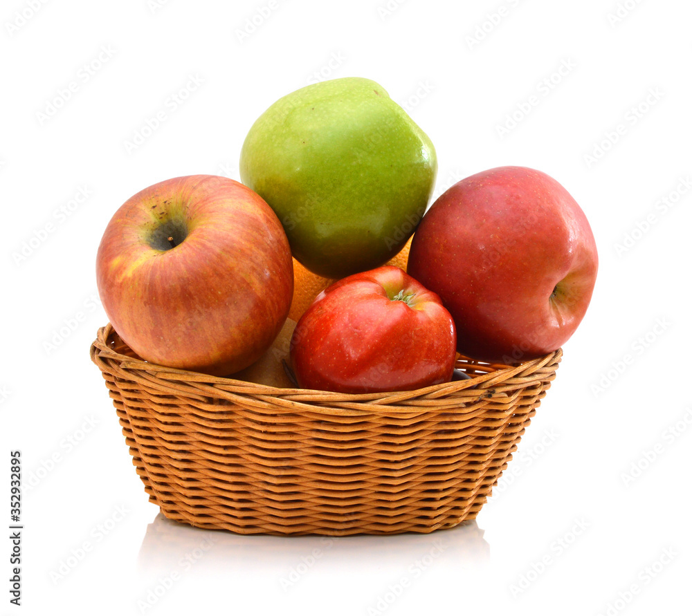 Apples in a wooden basket on white Apples in a wooden basket on white