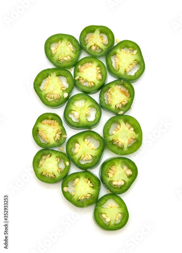 фотографія sliced green chilies on white background
