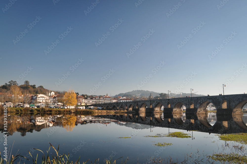 City view and stone old bridge across the river . Portugal.