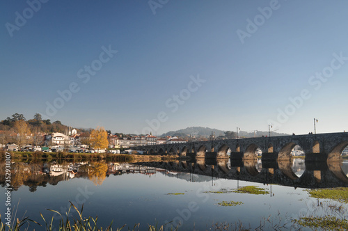 City view and stone old bridge across the river . Portugal.
