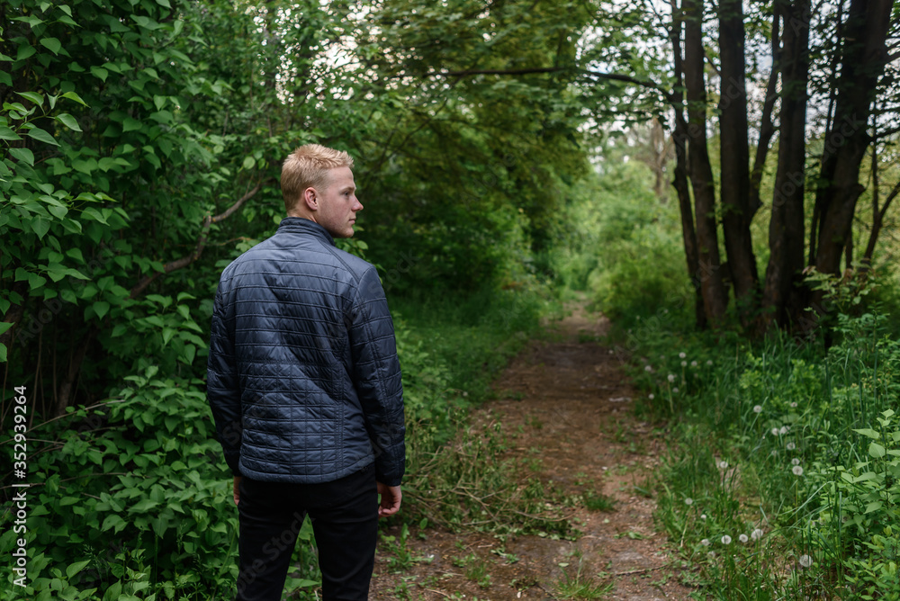 senior man walking in the woods senior man walking in the woods