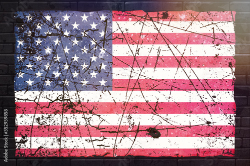 USA flag on a brick wall. Vintage effect, grunge style, flare in the top right. ideal for American state patriotism