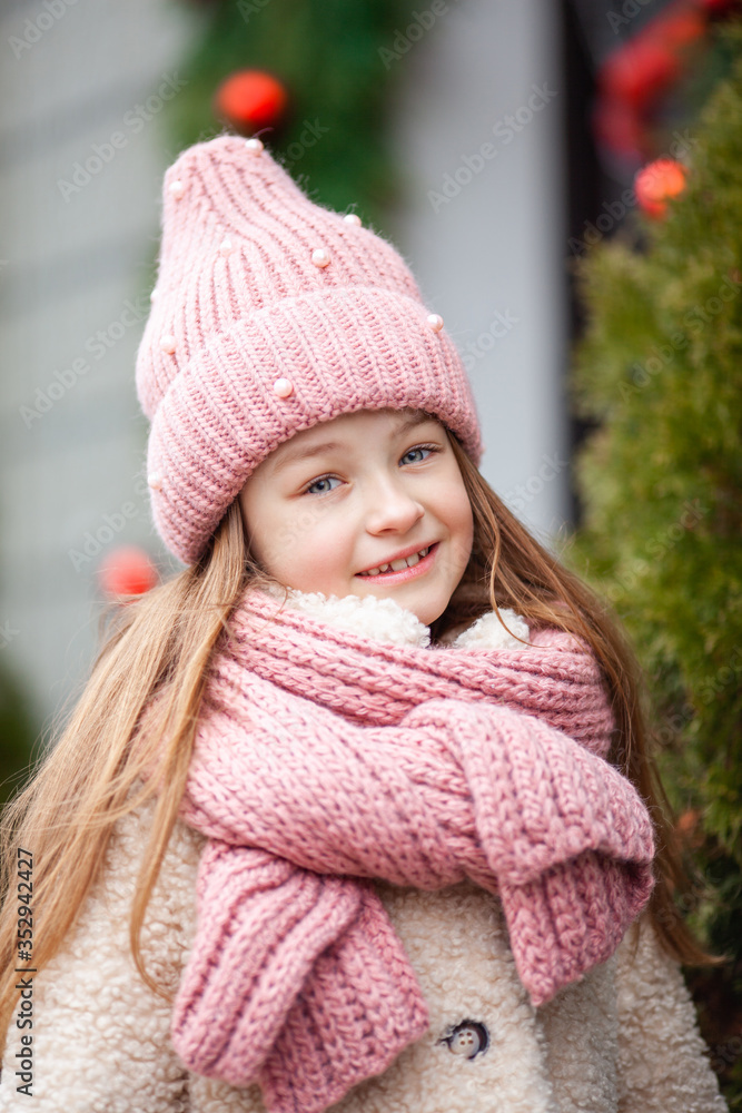 beautiful girl in winter clothes on the background of a street decorated for Christmas beautiful girl in winter clothes on the background of a street decorated for Christmas