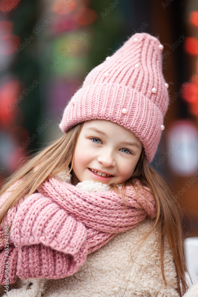 beautiful girl in winter clothes on a street background beautiful girl in winter clothes on a street background