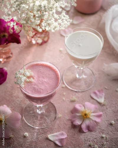 A glass of goats milk kefir with blended raspberries