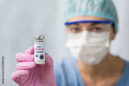 A doctor wearing gloves, mask, and spectacles with anti-COVID-19 vaccine against coronavirus.
landscape horizontal image orientation. White background.