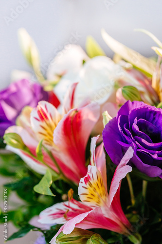 Stylish colorful floral bridal bouquet with roses. Designer fresh flower bouquet from a florist. Beautiful blossoming flower wedding designer bouquet. Close up view